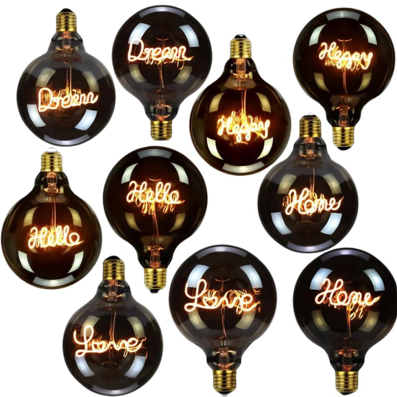 A collection of vintage style LED light bulbs with globe shapes, displaying various warm white inscriptions such as 'Dream', 'Happy', and 'Home'.