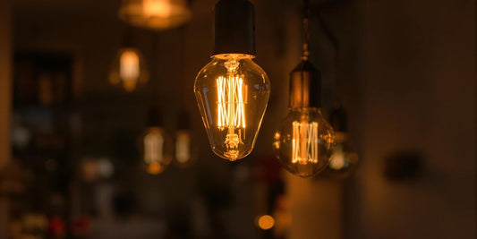 Vintage E14 LED bulb glowing in a modern setting.