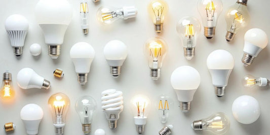 Various light bulbs on a neutral background.